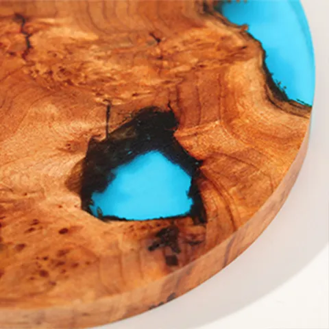 close up of natural wood resin coaster with artistic resin inlay design