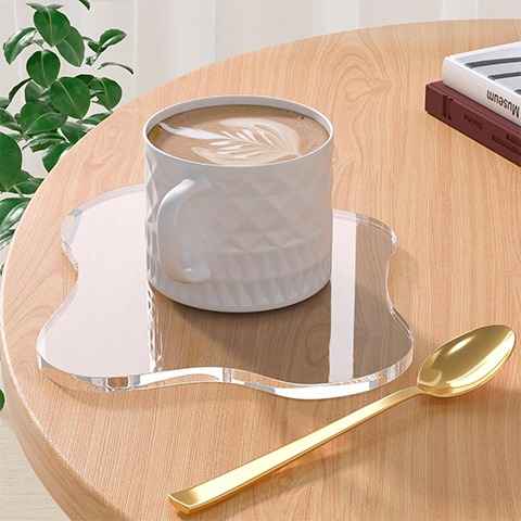 modern clear acrylic coaster used for coffee cup on minimalist tabletop